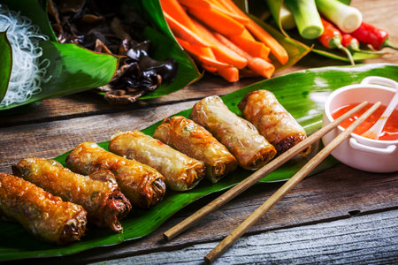 Fried spring rolls surrounded by ingredients