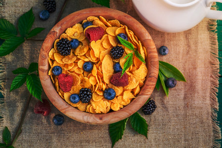 Tasty cornflakes with berry fruits and milk