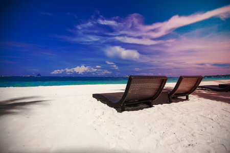 Beach wooden chairs for vacations and relax on tropical white sand plage
