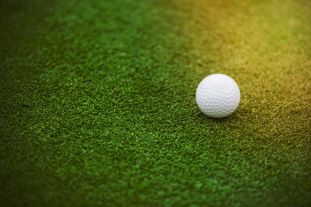 Golf ball on the green lawn, low depth of focusの写真素材