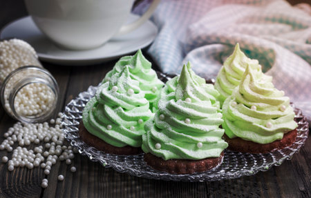 Homemade apple zefir fir-tree, placed on chocolate cookie and decorated with sugar ballsの写真素材