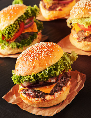 Delicious hamburgers served on black stoneの写真素材