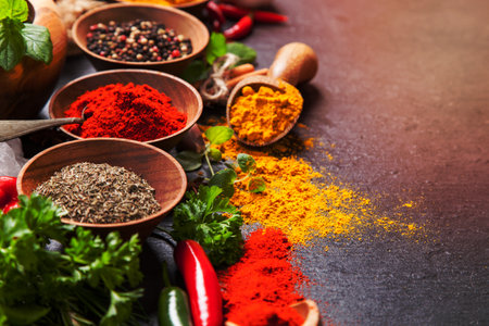 Various spices on black stone shot from aerial viewの写真素材