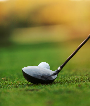 Golf club and ball in grass, low depth of focusの写真素材
