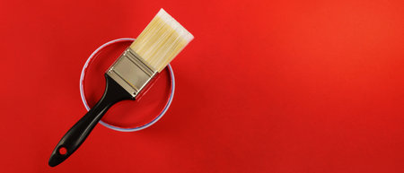 The cans of interior wall paint is placed on a red background.の写真素材