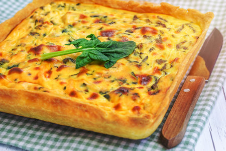 Ricotta spinach pie on the wooden table, closeup