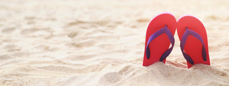 sea on the beach Footprint  people on the sand and slipper of feet in sandals shoes on beach sands background. travel holidays concept.の写真素材