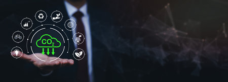 Businessman hand hold recycle symbol connection with virtual modern reduce CO2 emission concept with icons, global warming emissions carbon footprint climate change to limit global warming, energyの写真素材