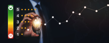 Businessman holding glowing light bulb with Customer review satisfaction feedback survey concept,...