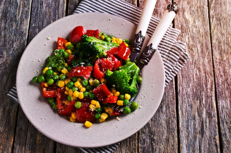 Cooked colorful vegetables, sprinkled with cheese. Selective focus.の写真素材