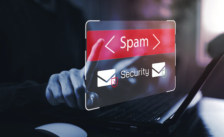 Email concept with laptop spam and virus computer monitor internet security concept, businessman reading electronic mail with a laptop. Spam, junk and e-marketing on screen, Spam Email Pop-up Warning.の写真素材
