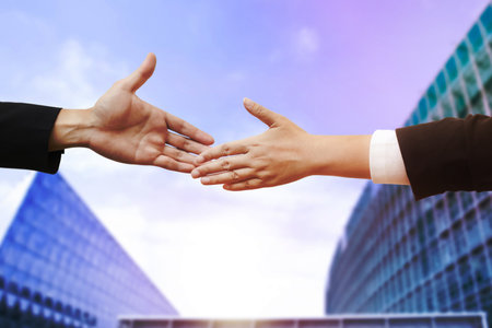 Double exposure of business Partner handshake between a man and a woman on blue sky background, business deal, handshake on modern blue background, Teamwork,support. Solidarity, compassion,の写真素材