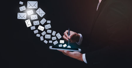 e-mail and marketing concept. Double exposure Businessman hand hold pen touch Email pressing for sending the e-mail from the laptop computer, Concept of sending emails from your computer,の写真素材