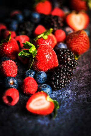 Berry mix on rustic black background