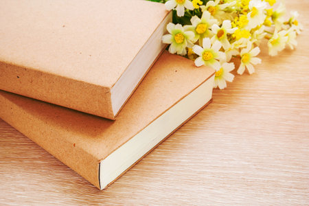Books and daisy flower
