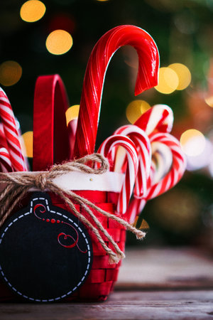 Candy canes in a basket on christmas backgroundの写真素材