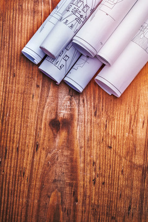 copyspace  image stack of white blueprints on old wooden boardの写真素材