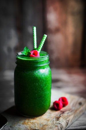 Fresh green smoothie on rustic wooden backgroundの写真素材