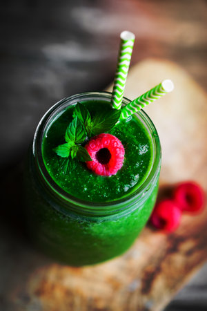 Fresh green smoothie on rustic wooden backgroundの写真素材