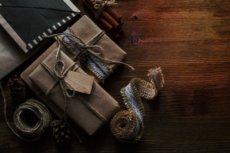 Presents in rustic wrap, wood background, copy space, top viewの写真素材