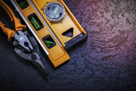 Tin snips construction level on black background.の写真素材