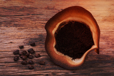 Coffee filter with brewed coffee on wood backgroundの写真素材