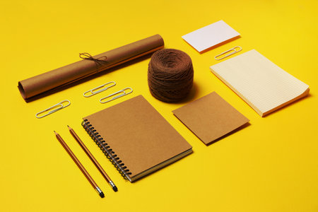 Mockup flat lay with different office accessories on yellow backgroundの写真素材