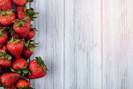 top view fresh strawberry on the left with copy space on white wooden backgroundの写真素材