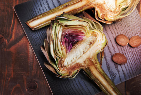 two halves of ripe artichoke on a wooden backgroundの写真素材