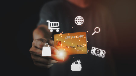 Businessman hand hold gold credit card and hologram with online shopping. Futuristic e-commerce online shopping concept.の写真素材
