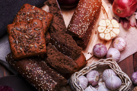 different bread and garlic on a wooden cutting boardの写真素材