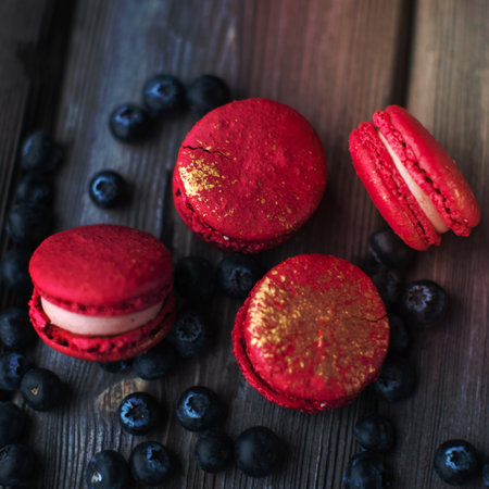 fresh macaroons and ripe blackberry on a wooden backgroundの写真素材