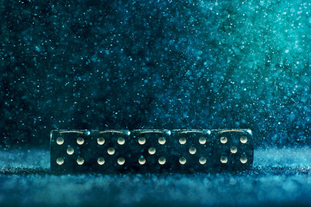 Horizontal shot of five identical black dice on a blue background. The concept of gambling.の写真素材