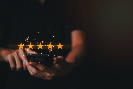 Businessman customer reviews 5 Stars with smartphone. Customer service evaluation and satisfaction. Top service, ISO certification, Guarantee, Quality assurance, Standards concept.の写真素材