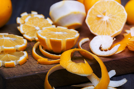 some sliced lemons on a wooden cutting board close-up in low keyの写真素材