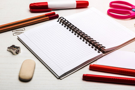 blank notebook and pencils and markers and scissors on white backgroundの写真素材