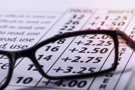Reading black eyeglasses and eye chart close-up on a light background