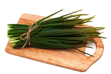spring onion on cutting board isolated on whiteの写真素材
