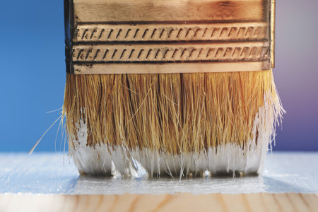 Horizontal shot of paint brush close-up. Painting the floor with white paint.の写真素材