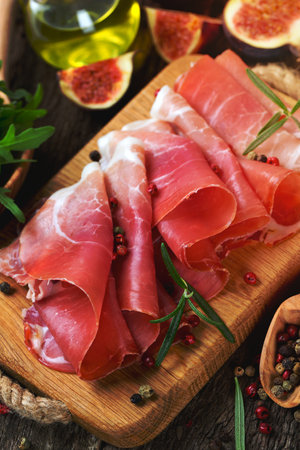 sliced prosciutto on a wooden boardの写真素材