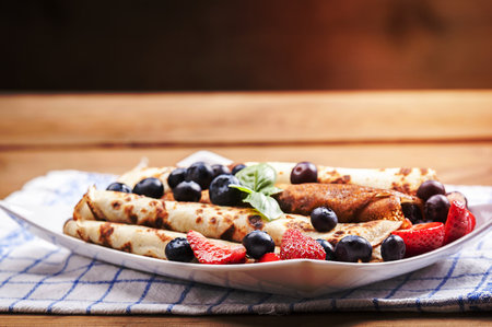 pancakes with fruit and chocolate sauceの写真素材