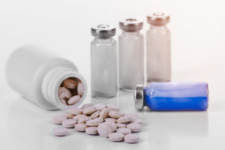 pharmacology. vitamins and tablets with vials and syringes. isolated on white backgroundの写真素材