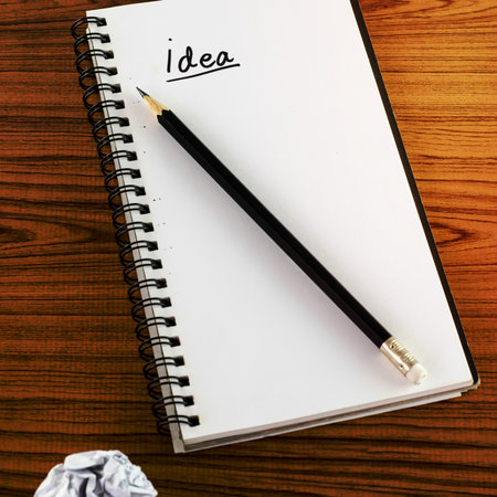 crumpled paper and pencil with notebook write idea word on wood background