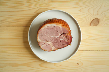 A photograph of a perfectly sliced piece of glazed baked hamの写真素材