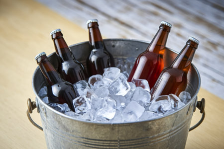 A photo of a bucket filled with ice and several bottles of beerの写真素材