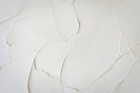 A minimalist photograph of a clean white textured surface