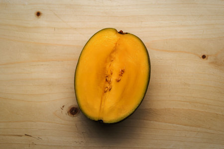 A photo of a yellow half mango