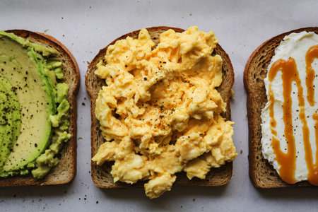 A photo of three slices of toast placed side by side on a white surfaceの写真素材