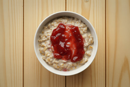 a white ceramic bowl filled with creamy oatmeal porridge