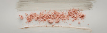 The image depicts a close-up view of a food item, with a white base topped with pink crumbs or...
